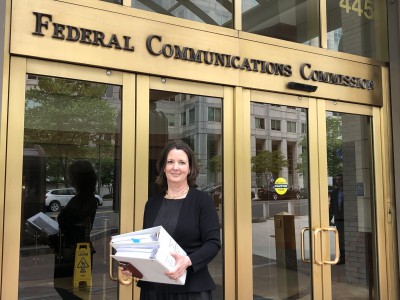 PTC Program Director Melissa Henson with member petitions for FCC Chairman Ajit Pai